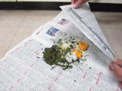 生ごみを新聞紙で包んでいる様子の画像